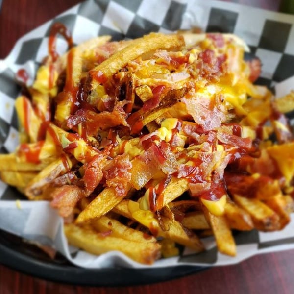 Loaded fries from Big Ray's Burgers & Dogs, topped with melted cheese, bacon, and ketchup.